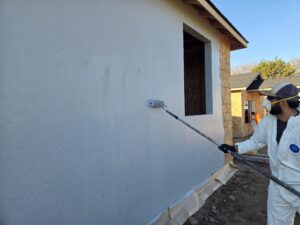 IWI employee doing exterior painting 
